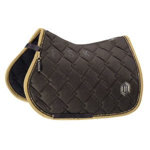 L'image présente une selle d'équitation élégante et sophistiquée. La selle affiche une couleur brune principale avec des bordures dorées, donnant une touche de luxe et de raffinement. Voici une description détaillée : 1. **Design et Matériaux** : La selle est fabriquée avec des matériaux de haute qualité. La surface supérieure est en tissu brun matelassé avec une texture légèrement brillante. Les bords sont finis avec une bordure dorée ornée de petites perles dorées, ajoutant une élégance...