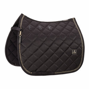 L'image présente une selle d'équitation élégamment conçue, de couleur noire, avec des détails sophistiqués. La selle est composée de deux parties principales : une partie supérieure et une partie inférieure. La partie supérieure est ornée de motifs géométriques en diagonale, créant un effet visuel subtil et raffiné. Les lettres "F", "S" et "K" sont brodées en gris sur cette partie, ajoutant une touche personnalisée à la selle. La partie inférieure de la selle est décorée d'un liseré doré...