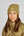 L'image représente une femme portant un bonnet d'hiver en tissu bouclé de couleur beige ou vert olive clair. Le bonnet est bien ajusté et couvre ses oreilles, offrant une protection contre le froid. Il comporte un petit emblème carré cousu sur le devant, probablement une marque ou un logo. La femme a de longs cheveux lisses et bruns qui tombent sur ses épaules. Elle porte également une veste beige ou vert olive clair, apparemment matelassée et légère, avec une fermeture éclair visible sur le...