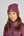 L'image montre une femme portant un ensemble de vêtements dans une teinte de bordeaux. Elle est vêtue d'un bonnet en tissu bouclé, doux et probablement chaud, orné d'un petit patch carré sur le côté gauche. Le patch semble être de la même couleur que le bonnet et porte un logo ou un symbole. En dessous du bonnet, la femme porte une veste matelassée légère et élégante, également en bordeaux. Cette veste est zippée jusqu'en haut et possède également un petit patch carré de la même couleur sur...